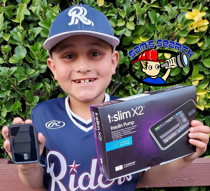 Josiah holding t:slim X2 insulin pump